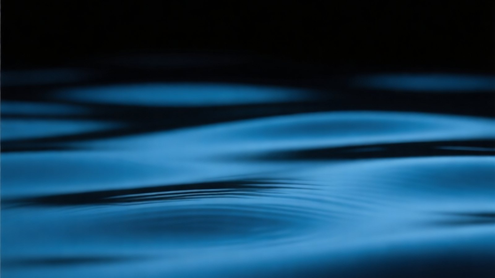 Slow-moving water in deep blue tones, evoking brown noise